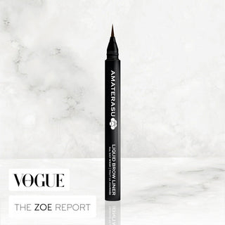 A black liquid brow liner pen with a micro-fiber brush tip, placed on a marble surface with the Amaterasu Beauty logo visible on the pen.